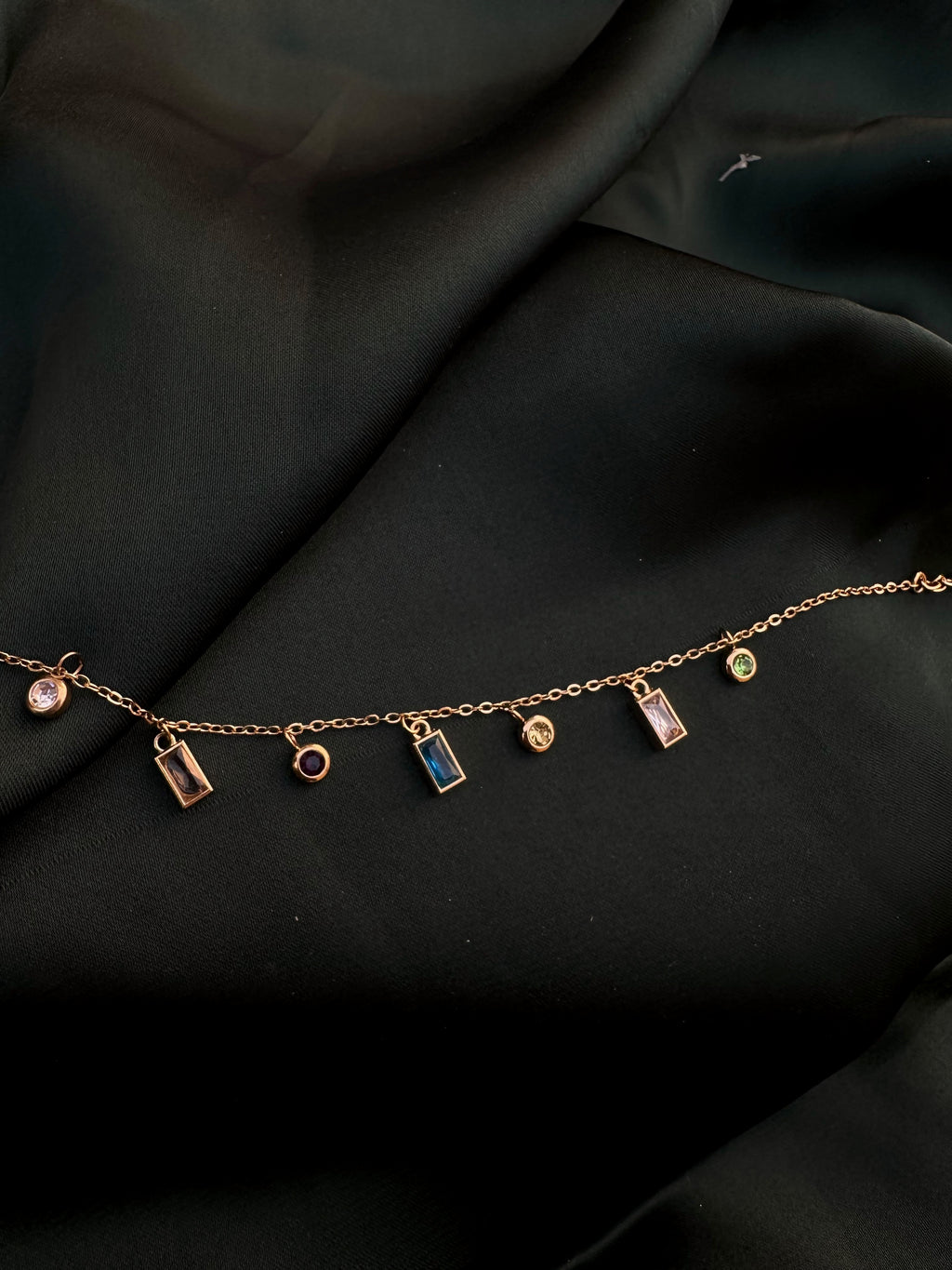 Crystal Charm Necklace on dark green silk