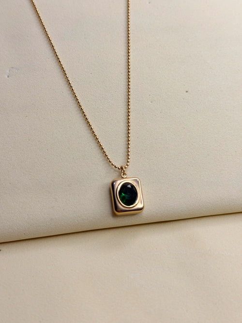 Green Emerald Necklace — emerald-green stone in a gold-toned square setting on a fine ball chain