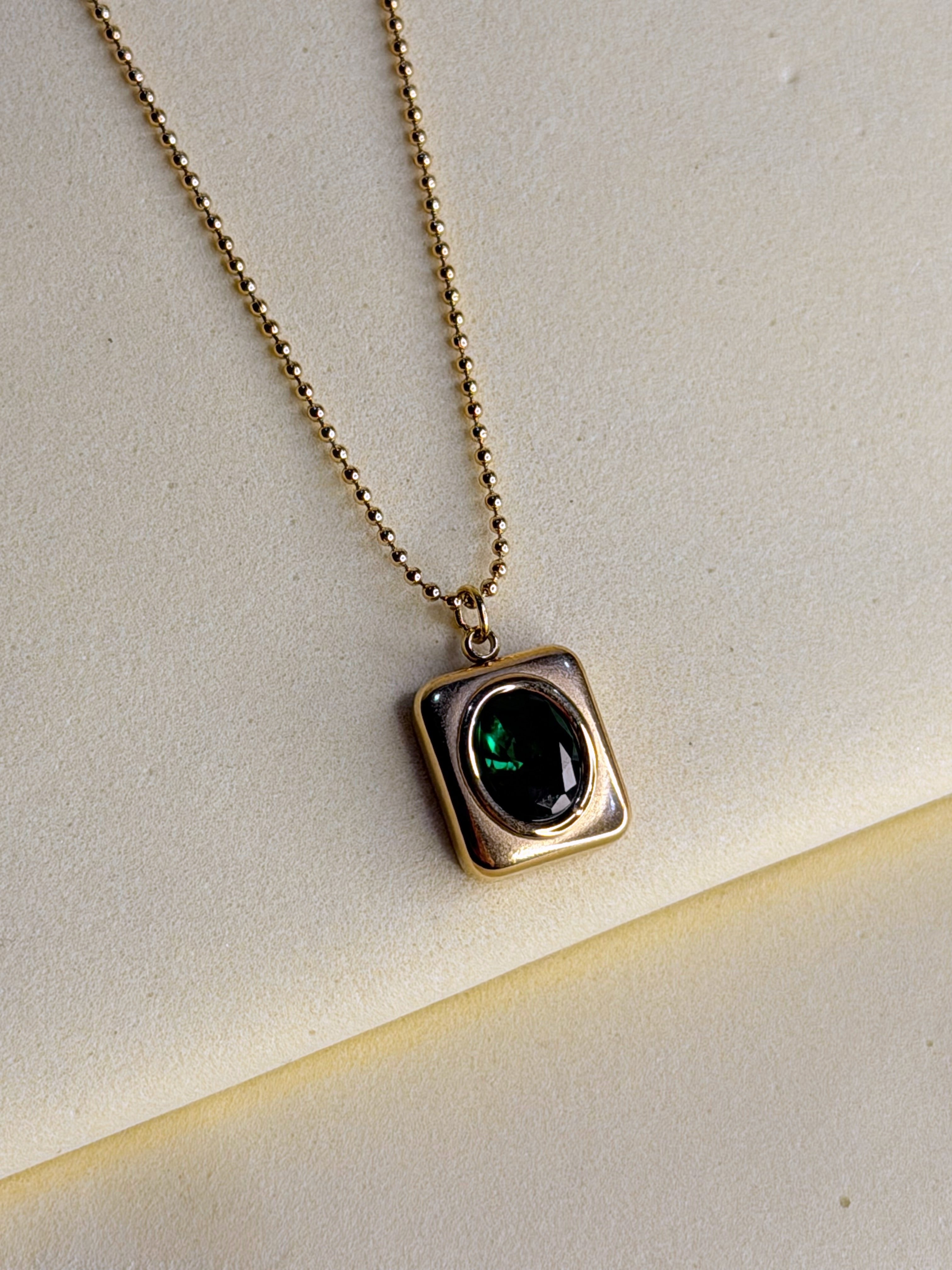 Green Emerald Necklace shown at an angle, catching the light