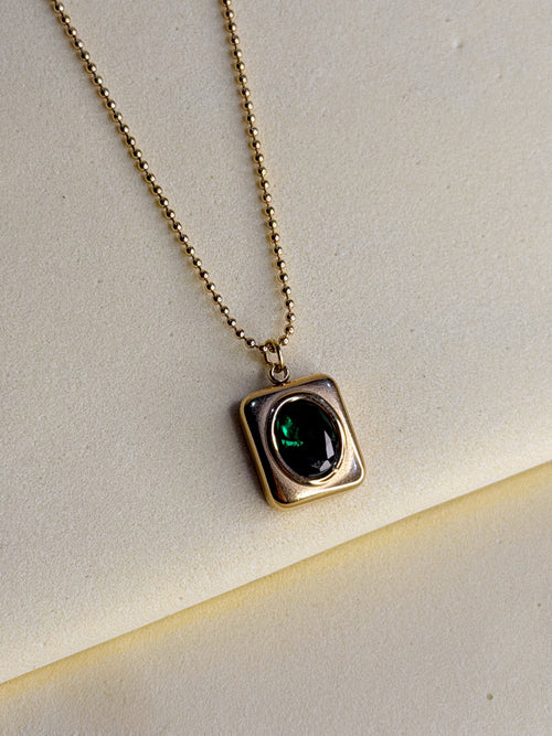 Green Emerald Necklace shown at an angle, catching the light