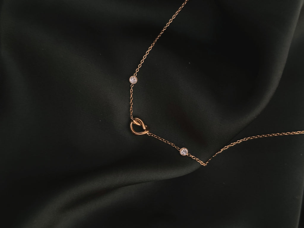 Infinite Love Necklace on dark green silk