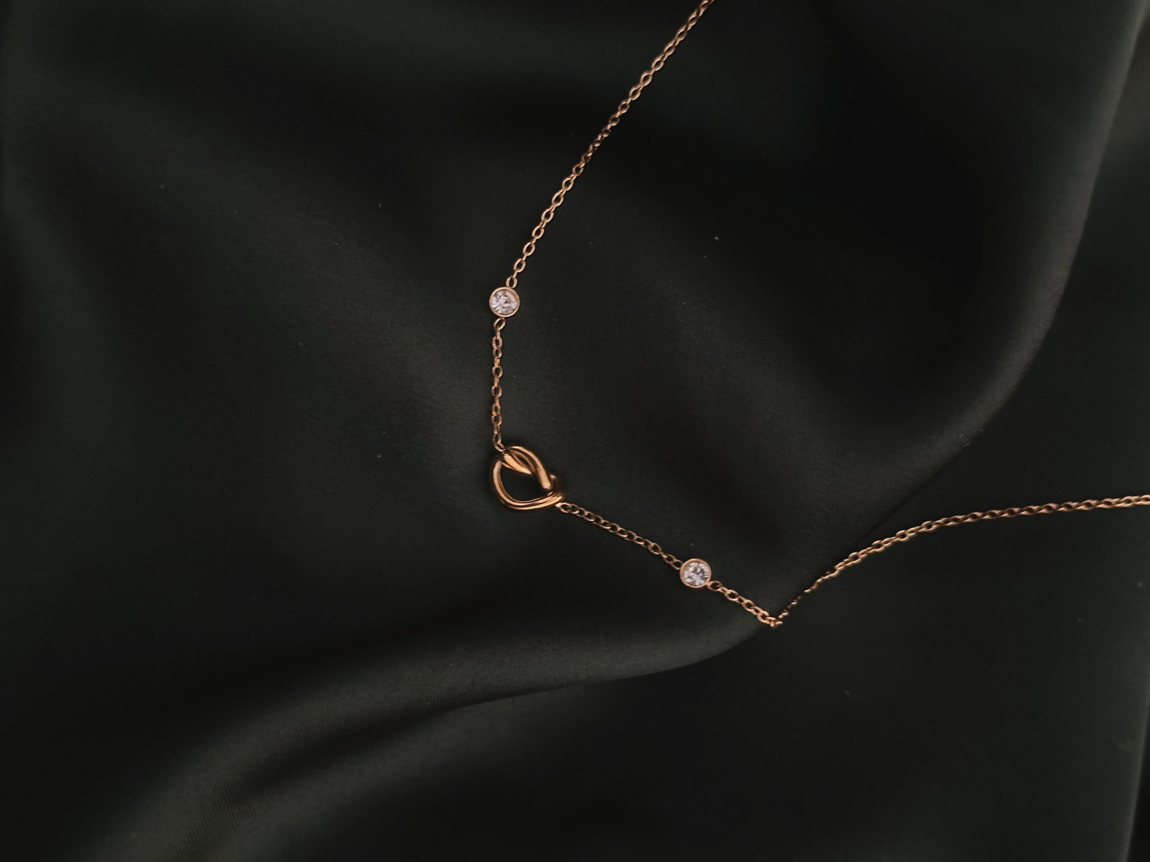Infinite Love Necklace on dark green silk