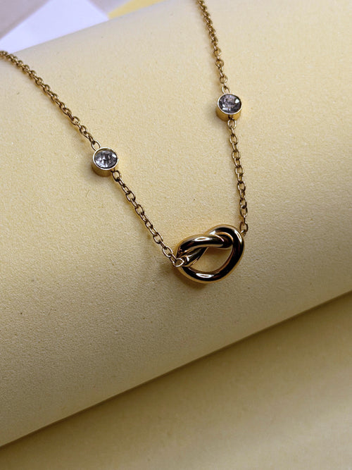 Infinite Love Necklace — gold-toned infinity knot pendant on a fine chain with crystal stations