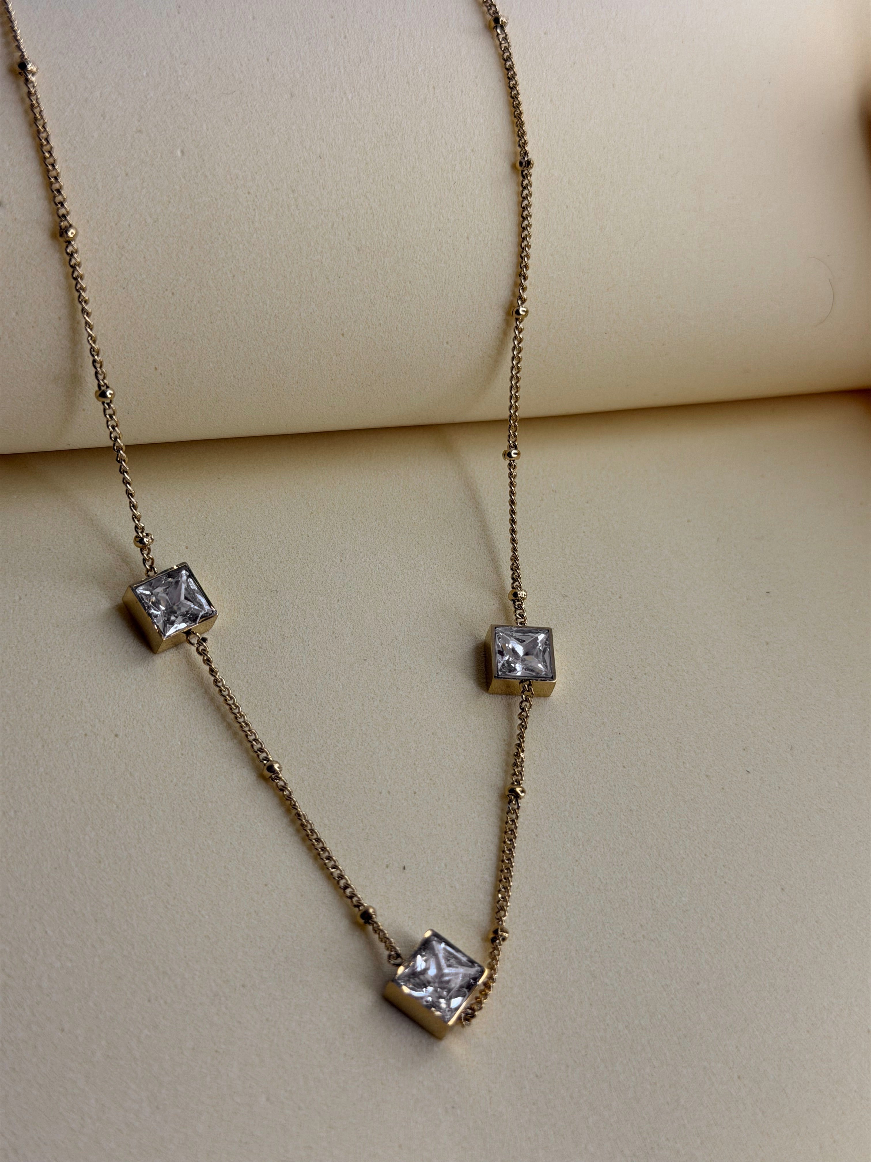 Midnight Ice Necklace — clear crystal stone suspended on a fine gold-toned chain