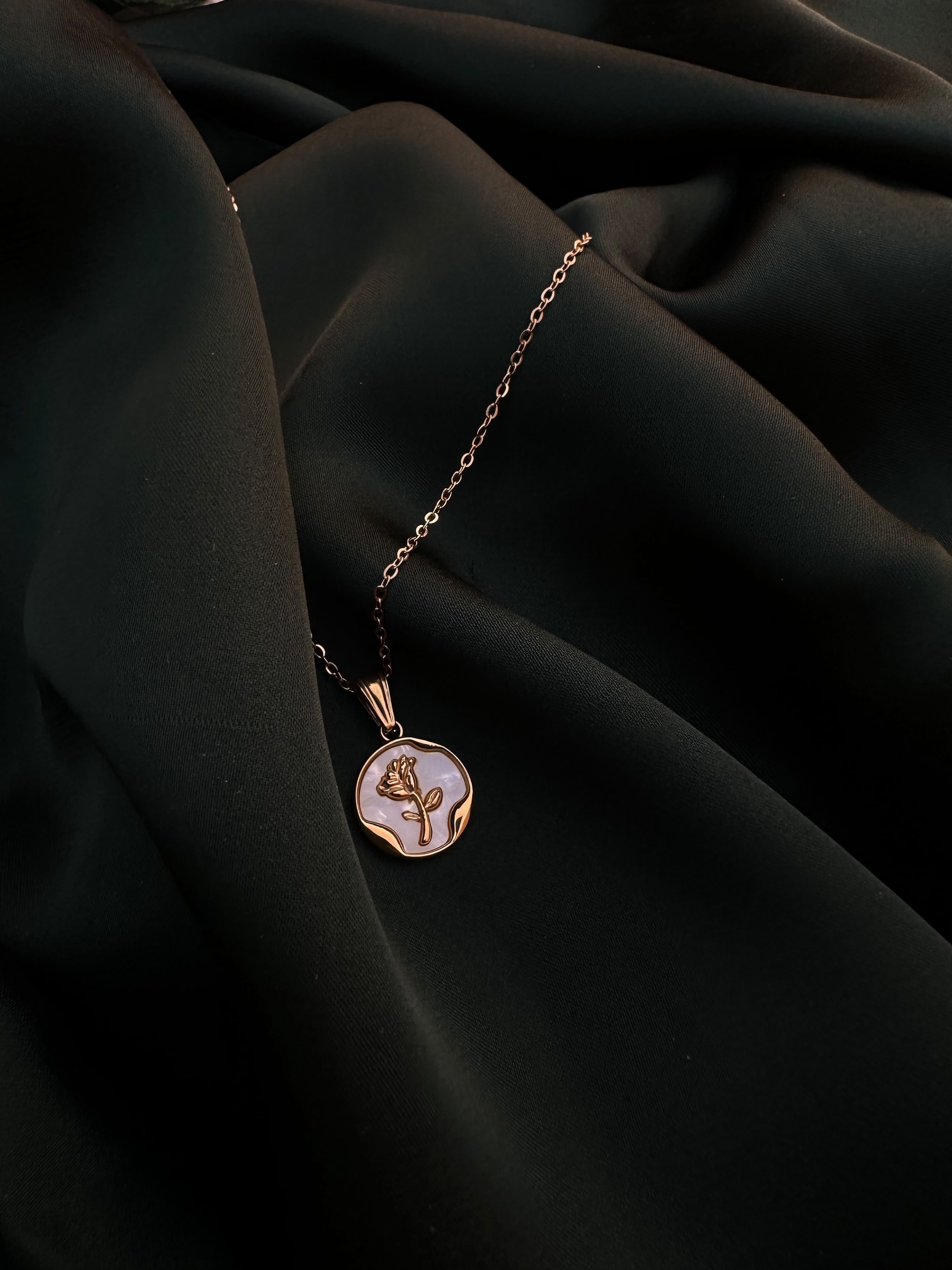 Pearl Coin Necklace rose pendant detail on green silk