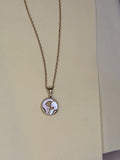 Pearl Coin Necklace — mother-of-pearl coin pendant with a gold rose motif on a fine chain