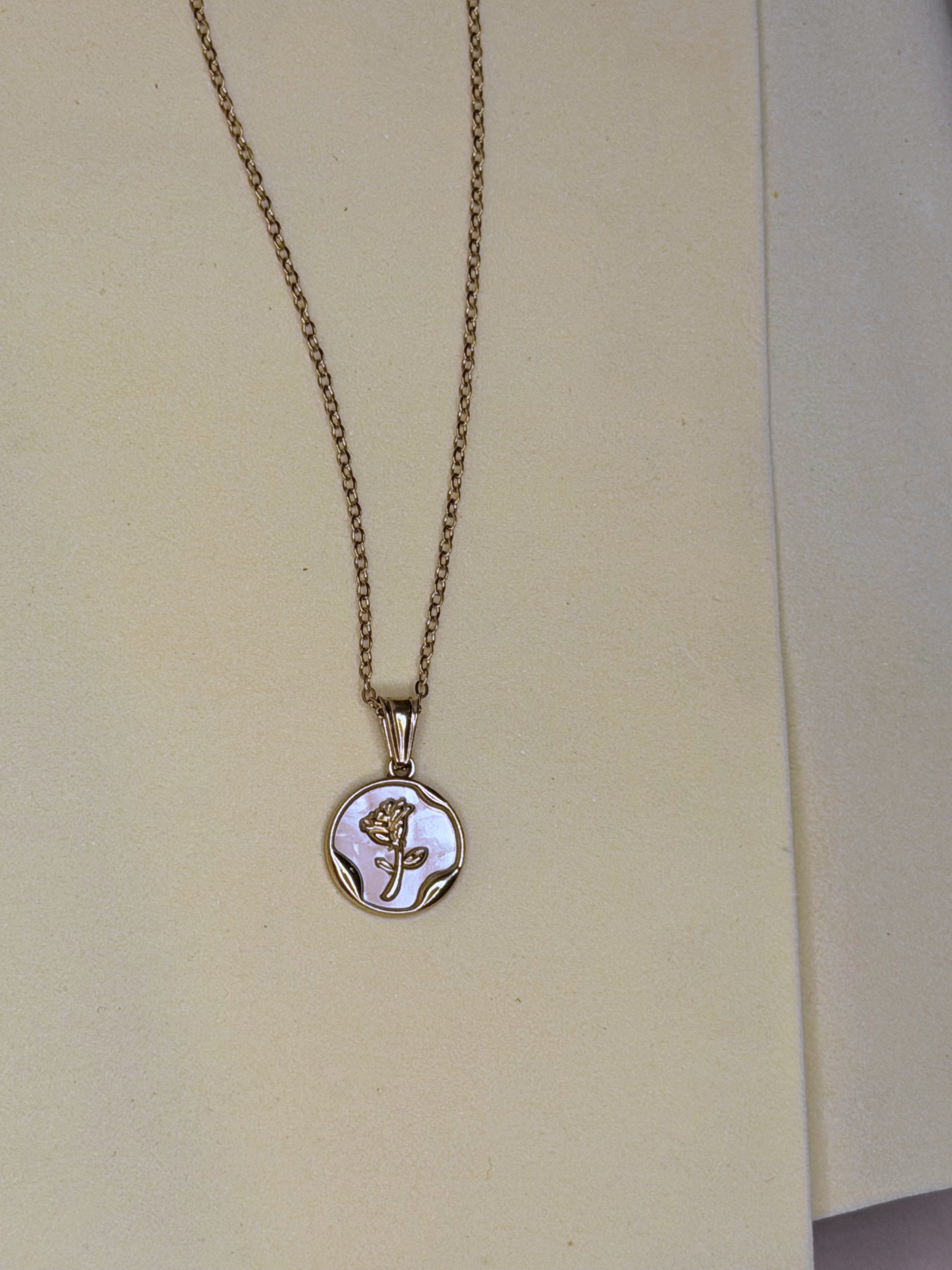 Pearl Coin Necklace — mother-of-pearl coin pendant with a gold rose motif on a fine chain