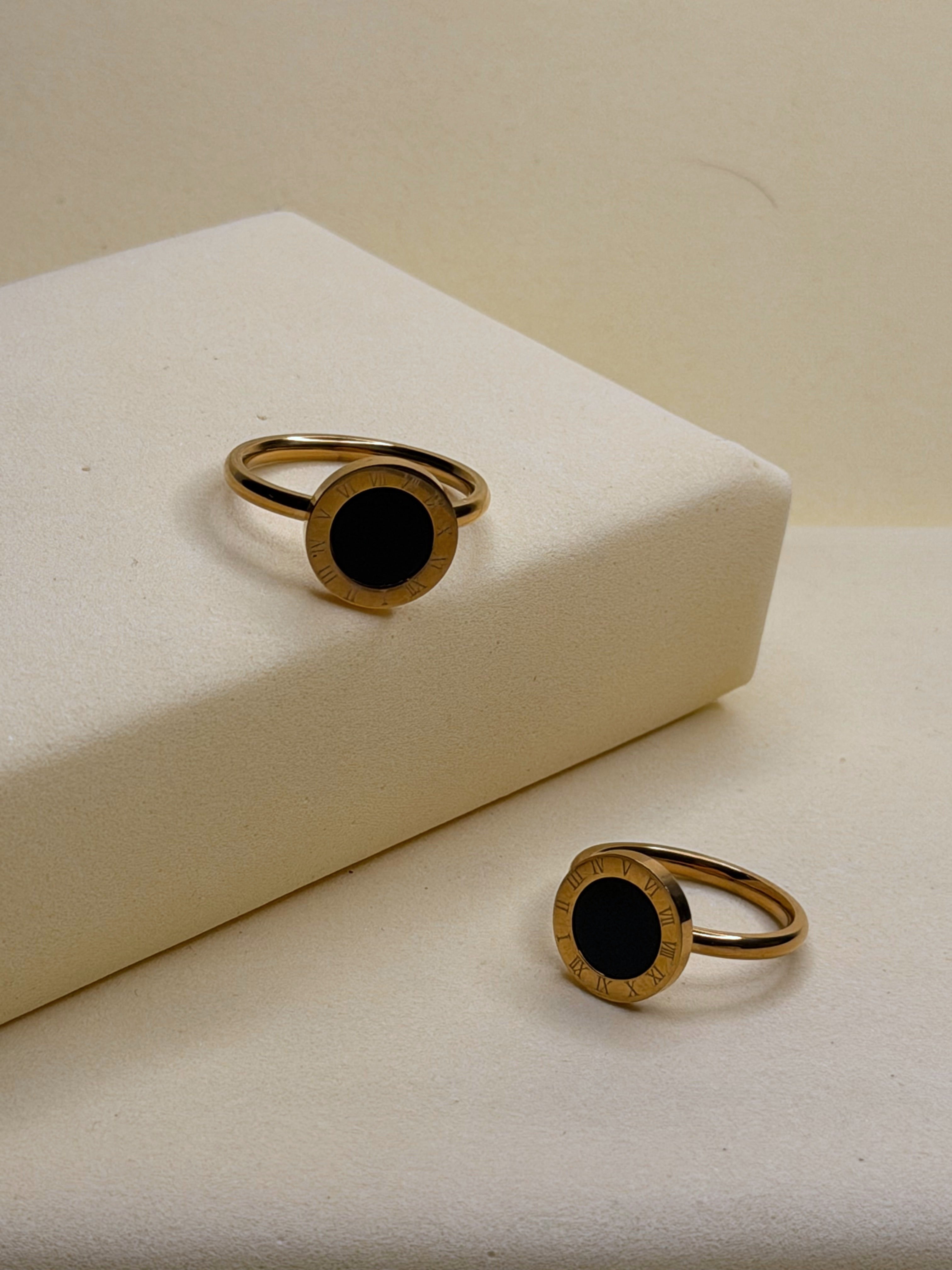 Roman Black Stoned Ring — black onyx disc framed by Roman numerals on a gold-toned band