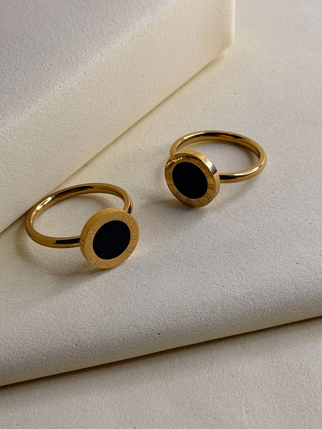 Roman Black Stoned Ring shown from above, two rings on a cream backdrop