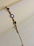 Roman Black & White Bracelet — onyx and mother-of-pearl discs on a gold-toned mesh band
