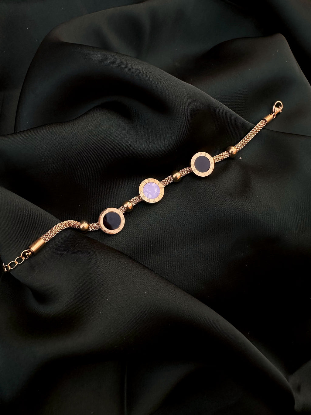Roman Black and White Bracelet on dark green silk
