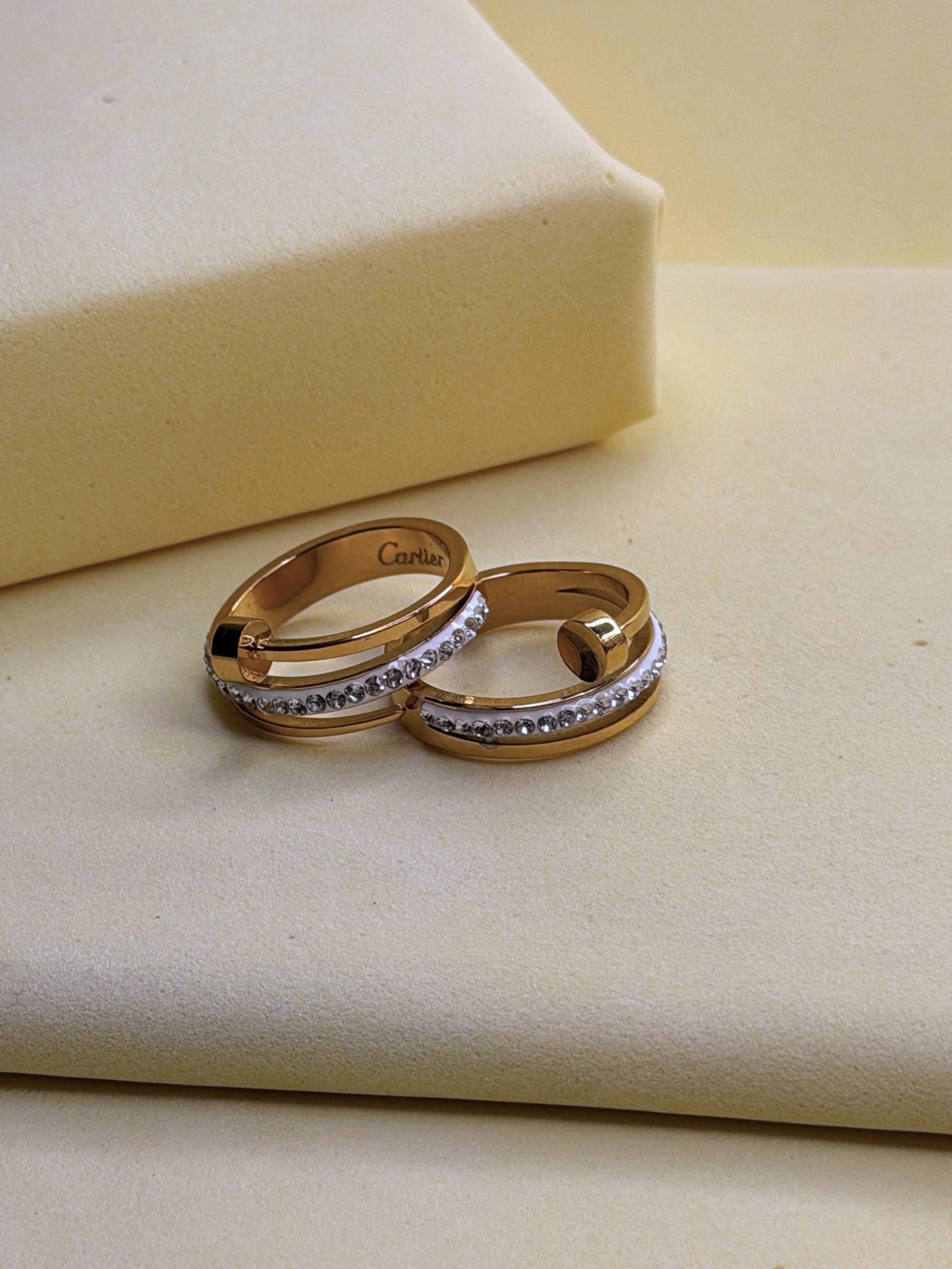 Triple Tier Orbit Ring shown from above on a cream backdrop
